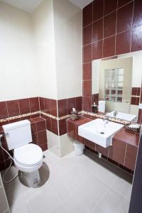 a bathroom with a toilet and a sink at Amatara Hotel in Pi Mai