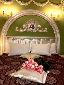 a bedroom with a large bed with flowers on it at Hotel Lavilia in Kyiv