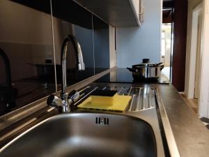 a kitchen counter with a sink and a sink at AVI City Burgplatz Apartments in Düsseldorf