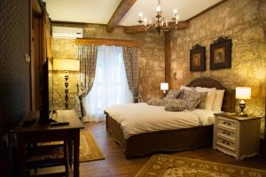 a bedroom with a bed and a dresser and a desk at kyrenia palace boutique hotel in Kyrenia