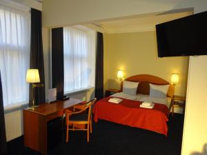 Postel nebo postele na pokoji v ubytování City Hotel Nebo