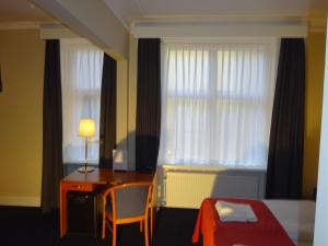 Postel nebo postele na pokoji v ubytování City Hotel Nebo