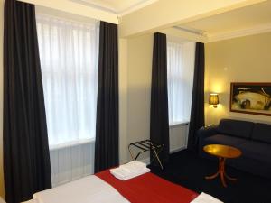 Postel nebo postele na pokoji v ubytování City Hotel Nebo