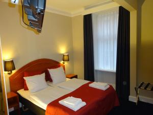 Postel nebo postele na pokoji v ubytování City Hotel Nebo
