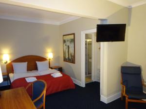 Postel nebo postele na pokoji v ubytování City Hotel Nebo