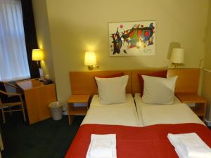 Postel nebo postele na pokoji v ubytování City Hotel Nebo
