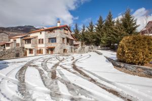 a snow covered road in front of a house at Villa Palaios Agios Athanasios in Palaios Agios Athanasios