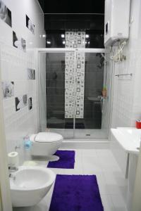 a bathroom with a toilet and a sink and a shower at Promenade Boutique Apartment in Bishkek