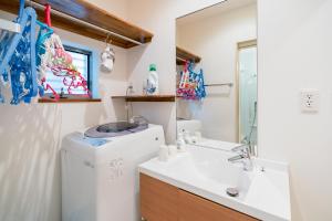 a bathroom with a sink and a washing machine at Yotsuya 110 in Tokyo +63 photos