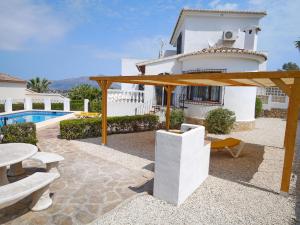 a villa with a swimming pool and a house at Villa Sophie - by Holiday Rentals Villamar in Benitachell