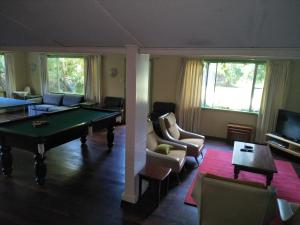 a living room with a ping pong table and a living room with a pool at Crystal Springs Holiday Accommodation in Walpole