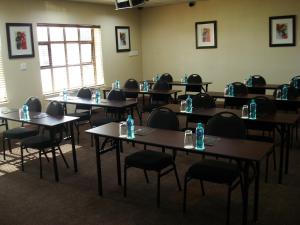 a room with tables and chairs with bottles on them at Peermont Metcourt at Frontier, Bethlehem in Bethlehem