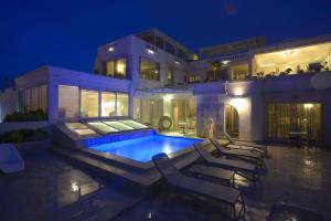 a large house with a swimming pool at night at Maison d'Hôtes Dar Ennassim in La Marsa