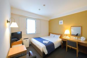 Postel nebo postele na pokoji v ubytování Shonandai Daiichi Hotel Fujisawa Yokohama