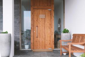 a wooden entry door with a sign on it at Sao Vicente Lodge - Atlantic Retreat in São Vicente Ferreira +37 photos