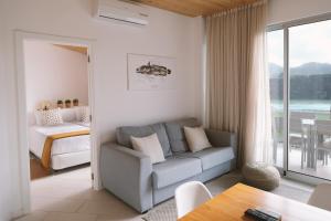 a living room with a couch and a table at Sao Vicente Lodge - Atlantic Retreat in São Vicente Ferreira