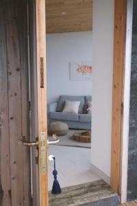 a door open to a living room with a couch at Sao Vicente Lodge - Atlantic Retreat in São Vicente Ferreira