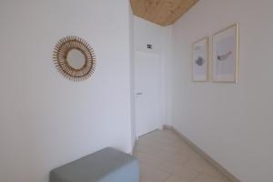 a room with a staircase and a mirror on the wall at Sao Vicente Lodge - Atlantic Retreat in São Vicente Ferreira