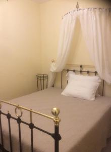 a bedroom with a bed with a white curtain at Kritikies Elyros in Pitsidia
