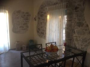 a room with a table with a bowl of fruit on it at Kritikies Elyros in Pitsidia