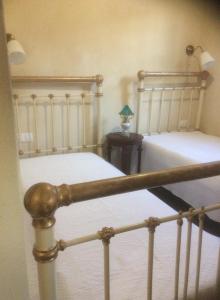 a bedroom with two beds and a side table at Kritikies Elyros in Pitsidia