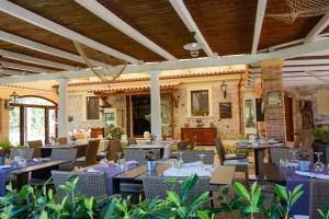 a restaurant with tables and chairs in front of a building at Residence e B&B Villamirella in Palinuro