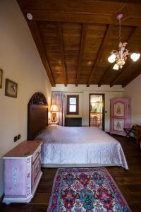 a bedroom with a large bed with a wooden ceiling at Boutique Hotel Kokkino Spiti in Veria