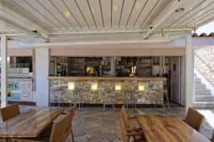 a restaurant with wooden tables and a stone bar at Camping Cavallo Morto in Bonifacio +7 photos
