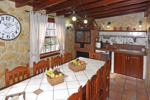 a kitchen with a table with baskets of fruit on it at Casa Maday in Villa de Mazo