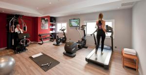 a woman standing on a treadmill in a gym at Calipolis in Sitges