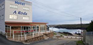 a hotel with the ocean in the background at Hotel A Roda in Valdoviño
