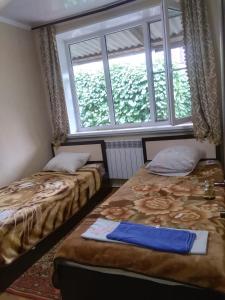 ピャチゴルスクにあるДом с уютными гостевыми комнатамиの窓付きの部屋 ベッド2台