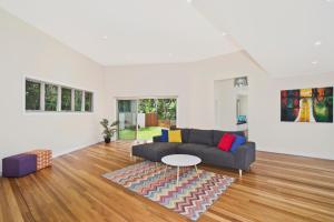 a living room with a couch and a table at Kilala - executive home in Port Macquarie
