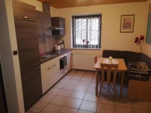 a kitchen with a table and a small table and a dining room at Haus Chrissy in Altmünster