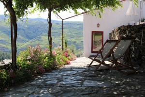 a bench sitting on a stone walkway with a view at Country house Quinta da Salgueira in Alijó