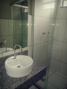 a bathroom with a sink and a glass shower at Hanna Palace Hotel in Barra do Piraí