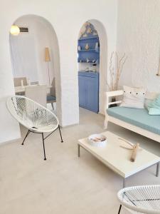 a living room with a couch and a table at Kyano House in Limenas