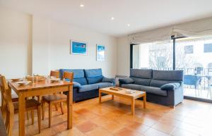 a living room with a blue couch and a table at Canadell 1º 3ª in Palafrugell