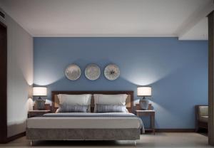 a bedroom with a blue wall with a bed and two lamps at Lara Park Hotel in Antalya +36 photos