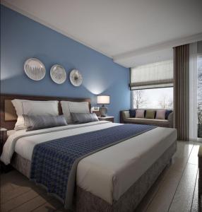 a bedroom with a large bed with a blue wall at Lara Park Hotel in Antalya