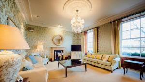 a living room filled with furniture and a chandelier at Alexander Residence in Perth