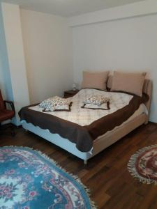 a bed with two pillows on it in a bedroom at Busteni Mountain Suites in Buşteni