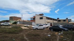 a group of cars parked in front of a house at Pousada Don'Ana in Conde