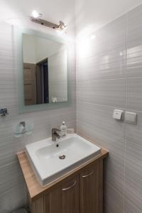 a bathroom with a sink and a mirror at Bed & Breakfast Hotel Perla in Nové Mesto nad Váhom