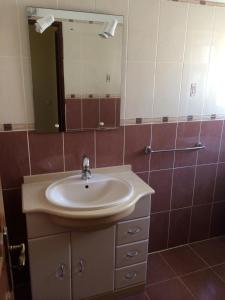 a bathroom with a sink and a mirror at Casa da Praia in Armação de Pêra