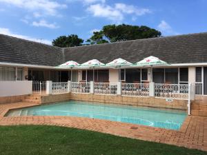a swimming pool in front of a house at Mandalay Bed & Breakfast and Conference Centre in Durban