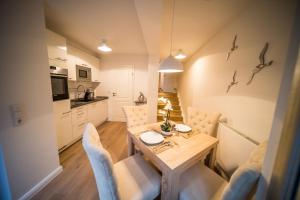 a kitchen and dining room with a table and chairs at Duenenschloss in Westerland (Sylt)