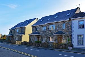 eine Reihe von Häusern mit Solardächern auf einer Straße in der Unterkunft Cottage 323 - Cleggan in Cleggan