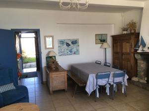 a bedroom with a bed and a table and chairs at FACE A LA MER , L ARTISTE in Ambleteuse +55 photos