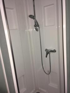 a shower with a glass door in a bathroom at FACE A LA MER , L ARTISTE in Ambleteuse